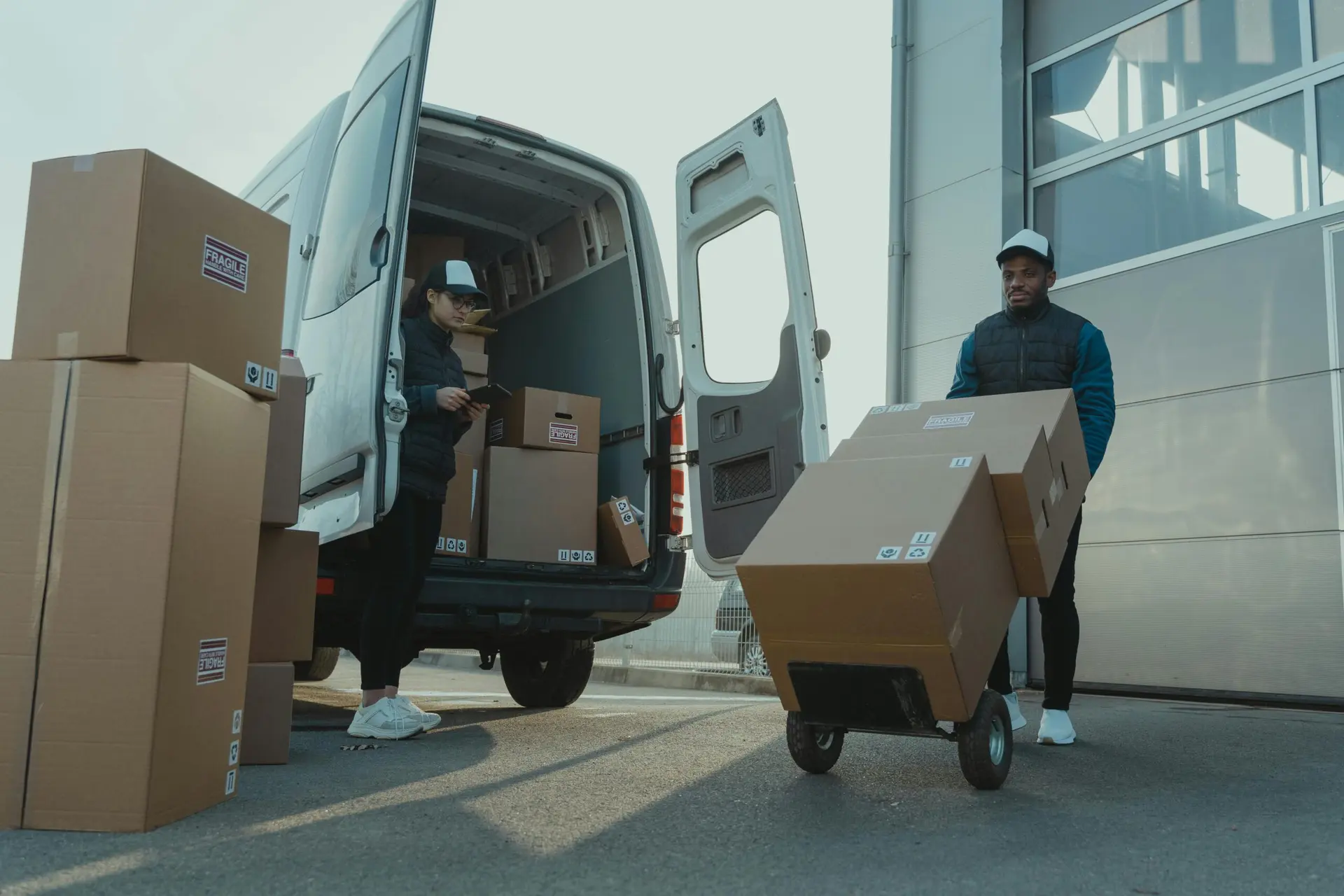 Global Pharma Distribution Nuvensa couriers loading pharmaceutical deliveries into a van