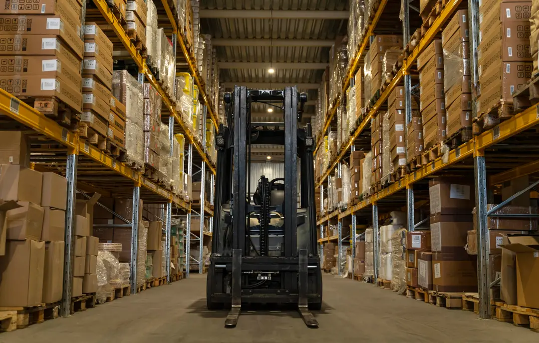 Procurement, Wholesale, and distribution Forklift moving stock through a pharmaceutical warehouse